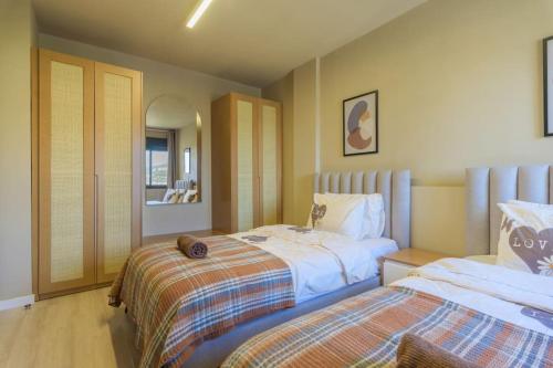 a bedroom with two beds and a mirror at Soukside Haven 3BR 24-7 Electricity in Batroûn
