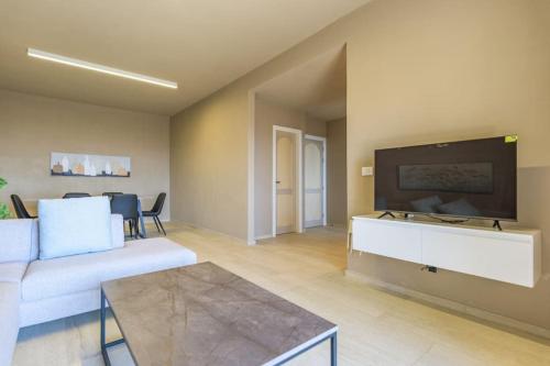 a living room with a couch and a flat screen tv at Soukside Haven 3BR 24-7 Electricity in Batroûn