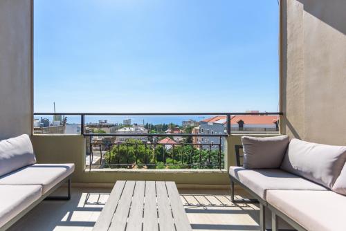 a balcony with couches and a view of the ocean at Soukside Haven 3BR 24-7 Electricity in Batroûn