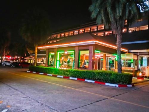a building with a palm tree in front of it at Eastpana Executive Residence 304 Prachinburi in Si Maha Phot