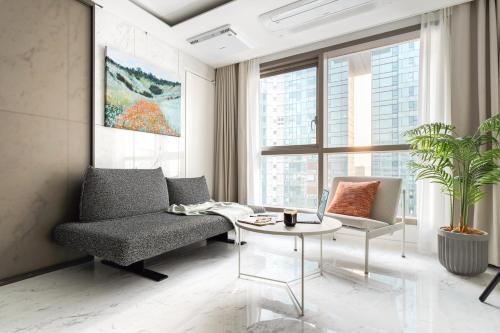 a living room with a chair and a table at Le Collective Gangnam SAC Roium in Seoul