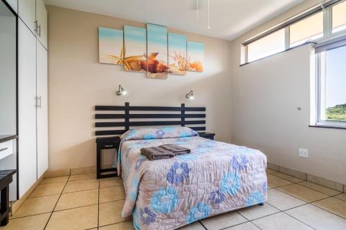 a bedroom with a bed and a desk at ATKV Natalia in Kingsburgh