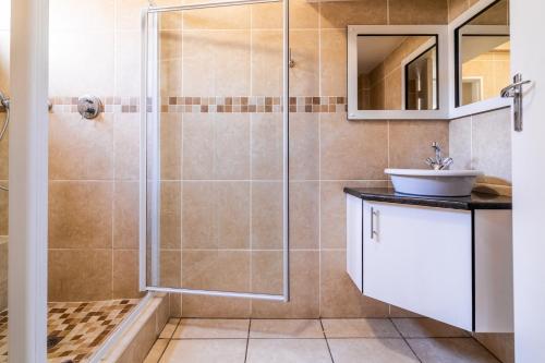 a bathroom with a shower and a sink at ATKV Natalia in Kingsburgh