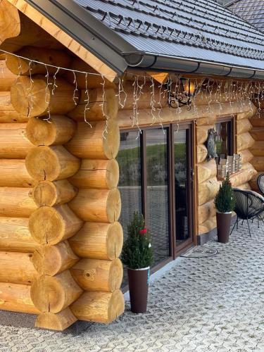 a log house with a wall of logs at Chalet -VV in Podčetrtek