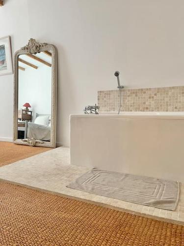 a bathroom with a white sink and a mirror at Maison bucolique champs de blé in Villers-Agron-Aiguizy