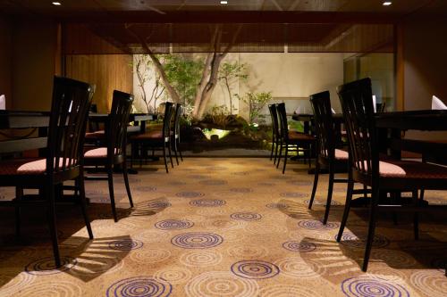 a row of chairs and tables in a room at Rihga Royal Hotel Kokura Fukuoka in Kitakyushu