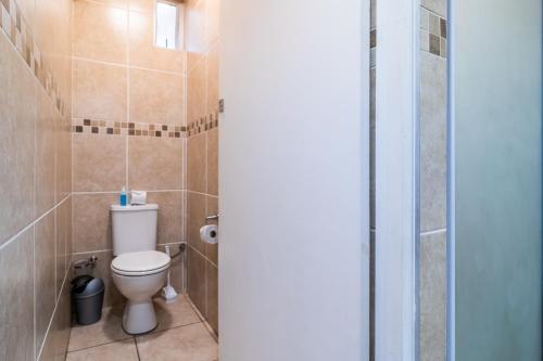 a bathroom with a toilet and a shower at ATKV Natalia in Kingsburgh