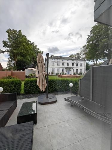 a patio with a statue and a building in the background at Gasthaus am Henriettenhof in Grömitz