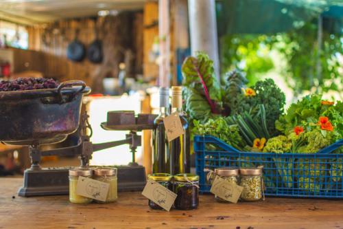 a table with a bunch of vegetables and jars on it at Nectar Rentals in Varákkes