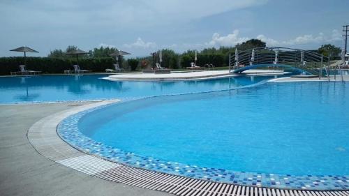 a large swimming pool with blue water at Siris Hotel in Serres