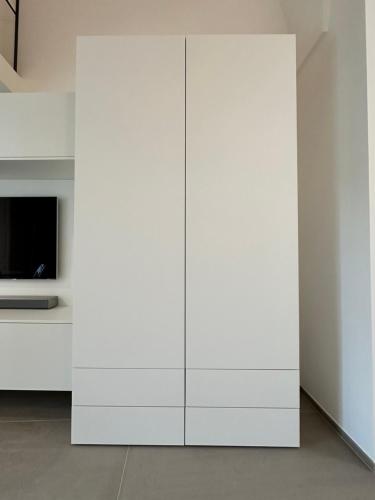 a white cabinet in a room with a tv at Design, comfort e atmosfera nel cuore del Salento in Martano