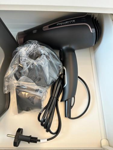 a hair dryer with a plastic bag and a whisk at Design, comfort e atmosfera nel cuore del Salento in Martano