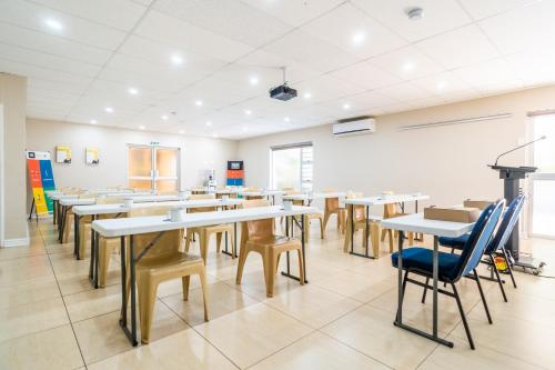 an empty classroom with tables and chairs at ATKV Natalia in Kingsburgh