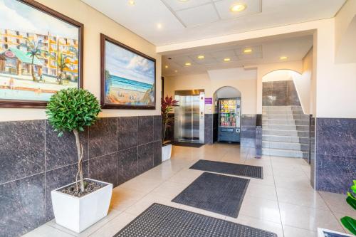 a lobby with stairs and a painting on the wall at ATKV Natalia in Kingsburgh