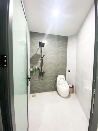 a bathroom with a shower with a toilet in it at Hidden Bungalow in Buôn Enao