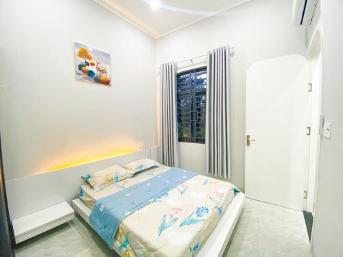 a bedroom with a bed with a rainbow in it at Hidden Bungalow in Buôn Enao