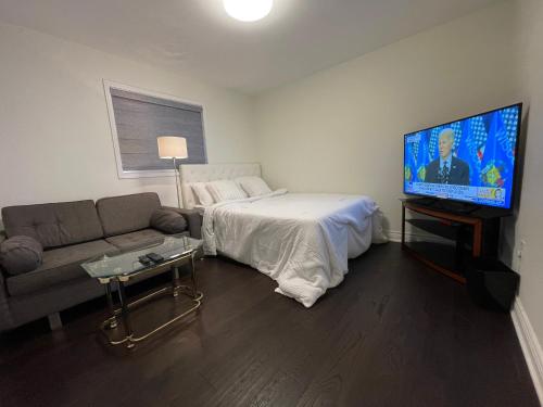 a living room with a couch and a flat screen tv at Finesse in Whitby