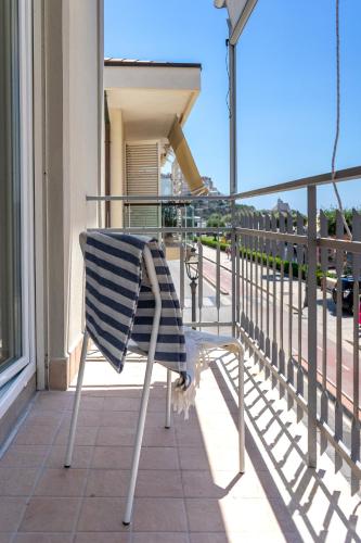a chair sitting on the balcony of a building at B&B Sperlonga in Sperlonga
