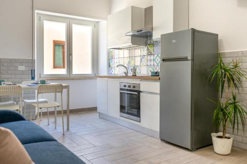 a kitchen with a stainless steel refrigerator and a table at B&B Sperlonga in Sperlonga
