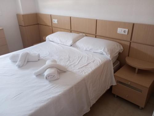 a hotel room with two beds with towels on them at Torre la Sal - Edificio Mediterráneo 1- Vistas al parque natural in Cabanes