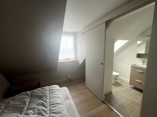 une chambre avec un lit et une salle de bain avec une fenêtre dans l'établissement les hauts du lac, à Éguzon-Chantôme