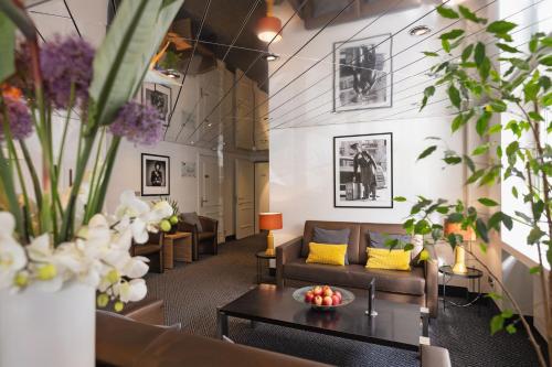 a living room with couches and a table at Hotel Stoller in Zürich