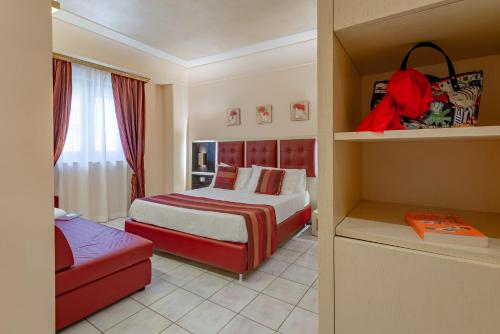 a hotel room with a bed and a couch at Fazio Rooms in Sciacca