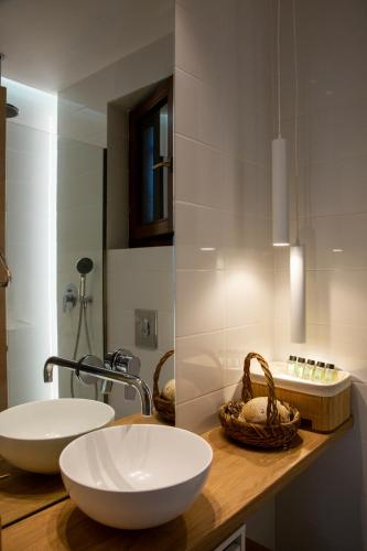 a bathroom with two white sinks on a counter at Theros Aegean Villa in Iraklitsa