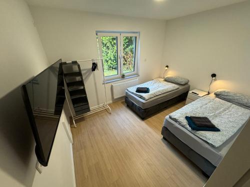 a small room with two beds and a staircase at Big House I 15 Beds I 8 Sleeping Room I Parking in Bad Oeynhausen