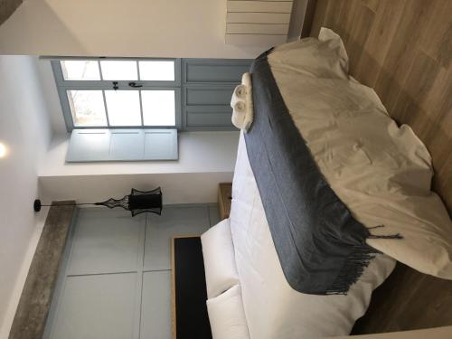 a large bed in a room with a window at Casa do queixeiro in Castroverde