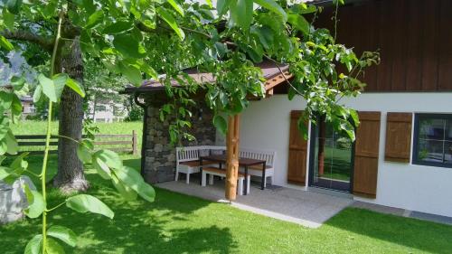 a table and a bench in the yard of a house at Gartenhaus Zur Kröllin in Mayrhofen