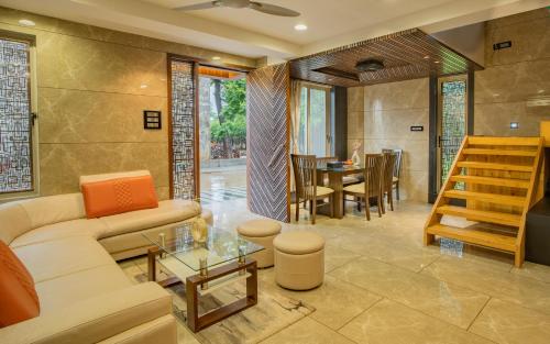 a living room with a couch and a table at Alaya Stays - Imperial Serenia 3BHK near Khandala Hills in Lonavala