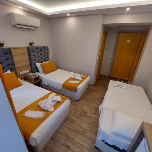 Ένα ή περισσότερα κρεβάτια σε δωμάτιο στο Kent Otel