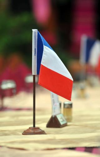 a small flag on a wooden stand on a table at Maeyom Palace Hotel in Phrae
