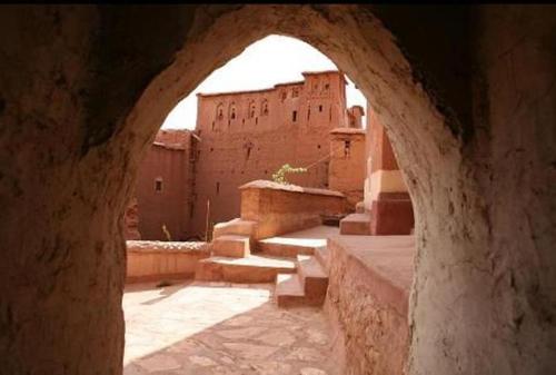 an archway in front of a building with stairs at Kasbah Tigmi N'Oufella in Telouet