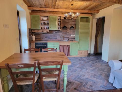 a kitchen with a wooden table and chairs at Rose garden in Ljubno