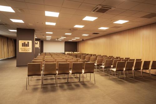 an empty lecture hall with chairs and a podium at Hotel City Maribor in Maribor