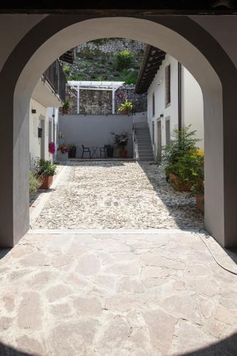 an archway leading to a courtyard in a building at Ai Priori in Gemona del Friuli