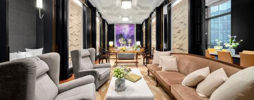 a living room with couches and a table at Mandarin Oriental, Guangzhou in Guangzhou