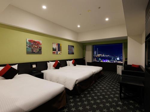a hotel room with two beds and a window at The Park Front Hotel at Universal Studios Japan in Osaka