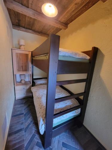 two bunk beds in a room with a ceiling at Rose garden in Ljubno