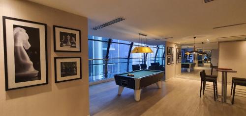 a living room with a pool table in a room at M CITY AMPANG, KLCC pool view in Kuala Lumpur