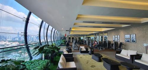 an office lobby with a view of a city at M CITY AMPANG, KLCC pool view in Kuala Lumpur