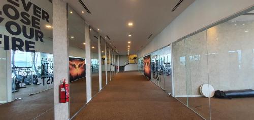 a hallway in a building with posters on the walls at M CITY AMPANG, KLCC pool view in Kuala Lumpur