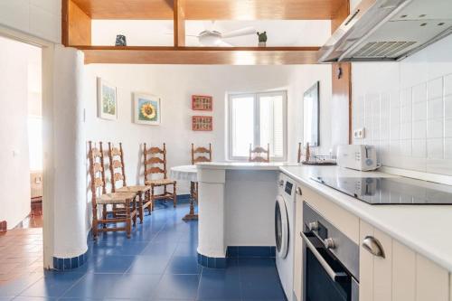 a kitchen with white counters and a blue floor at Casa de la Media Luna in El Pozo del Cabo