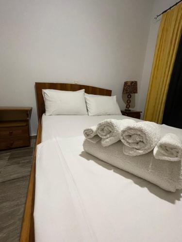 a bedroom with a bed with towels on it at Mama’s Sunshine Garden Villa in Áyios Ilías