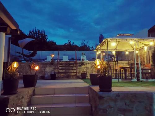a greenhouse with lights in a yard at night at Casa Ilici in Sviniţa