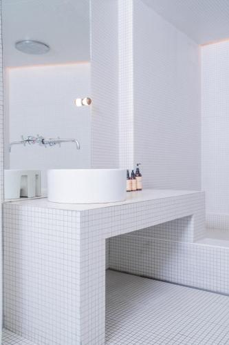 a white bathroom with a sink and a mirror at Gangnam Boutique Hotel Sohsul in Seoul