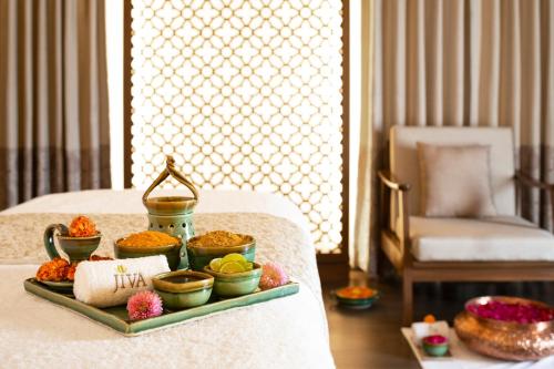 a tray with different types of food on a bed at Taj Ganges Varanasi in Varanasi