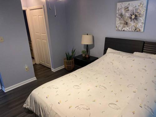 a bedroom with a bed with a white comforter at Welcome International Guests-Medical Residents-free shuttle downtown-full kitchen- free parking in Memphis